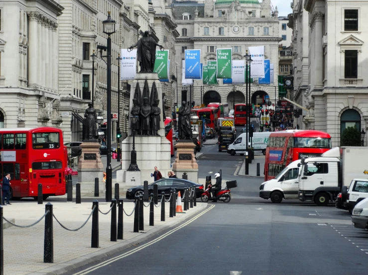 a street is lined with a lot of buses and other traffic