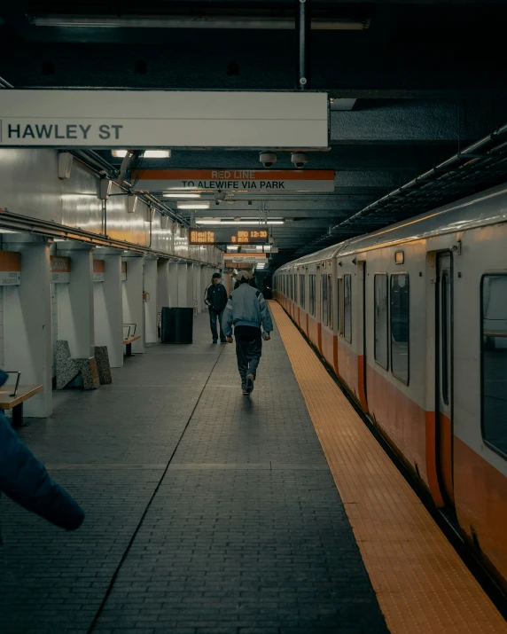 people walking in line next to subway train