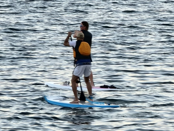 the man is standing on his surfboard and looking at soing