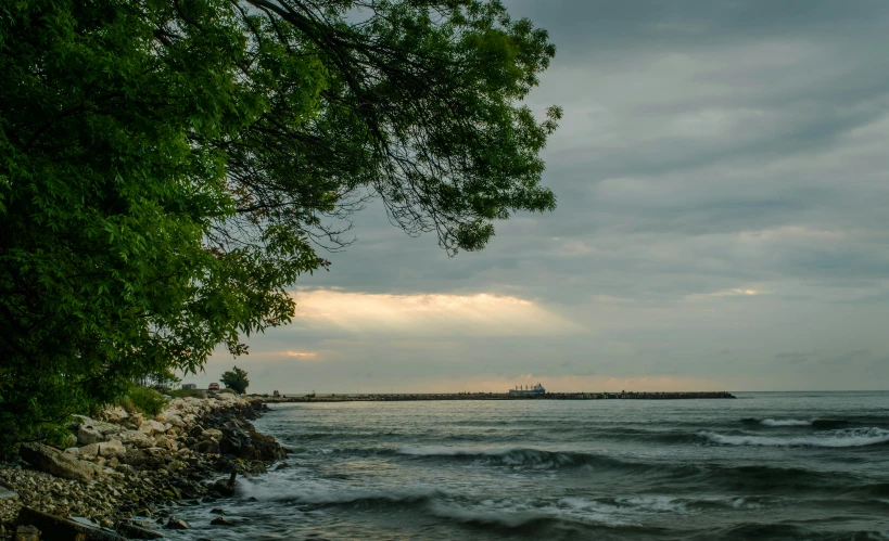 the ocean is calm and quiet as the sun shines over the horizon