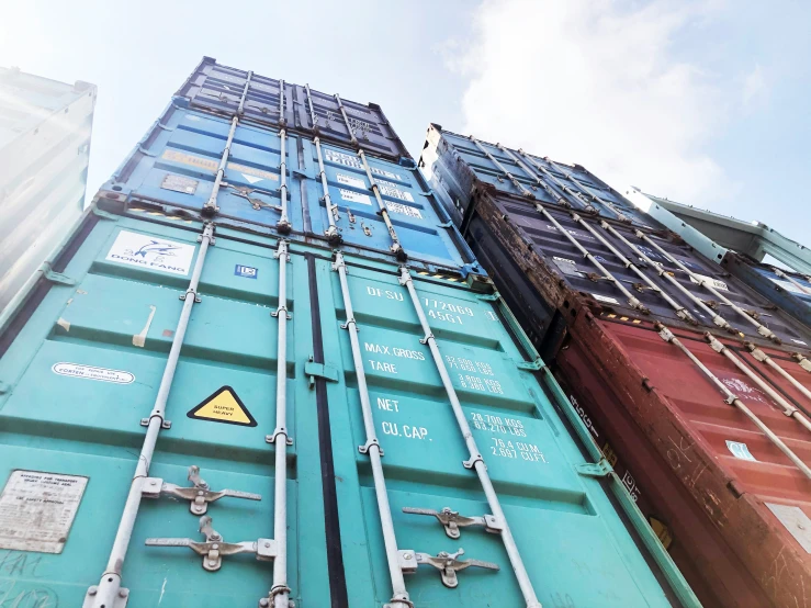 large cargo container stacked up against a tall building