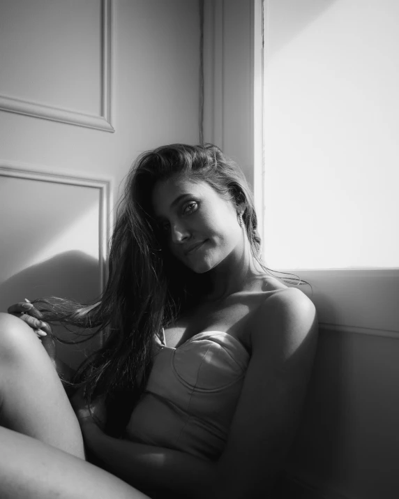 a woman posing in her underwear with long hair