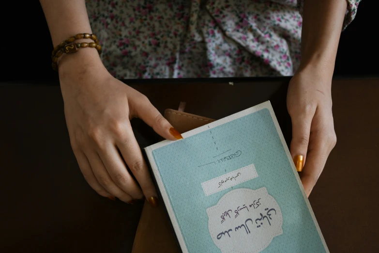 a woman is holding up a book in her hands