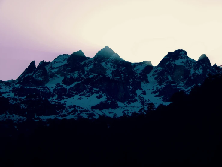 the mountain is covered in snow and has dark colors