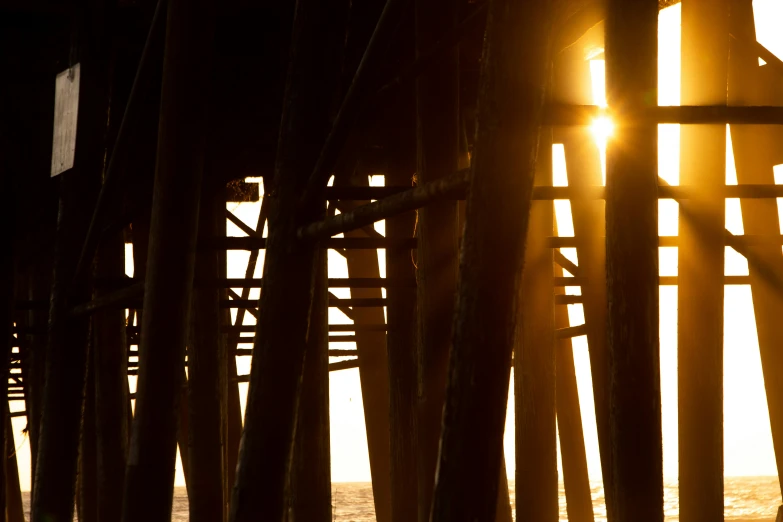 sunlight is shining brightly through a wooden structure