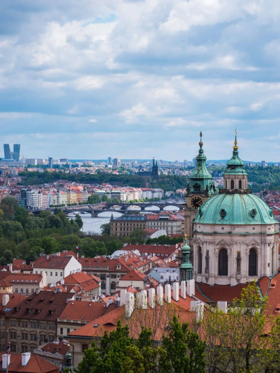 view from atop of large city buildings with rooftops and dome