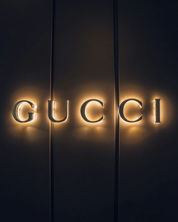 the word gucci illuminated up against the wall