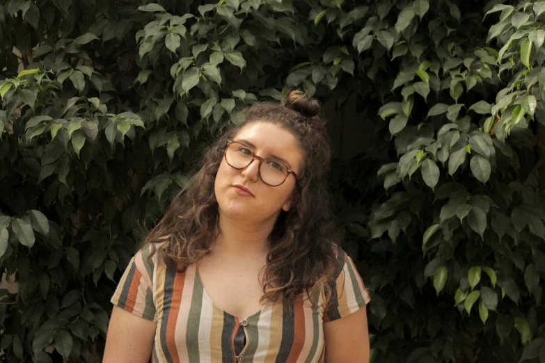 the woman in glasses is posing with the camera