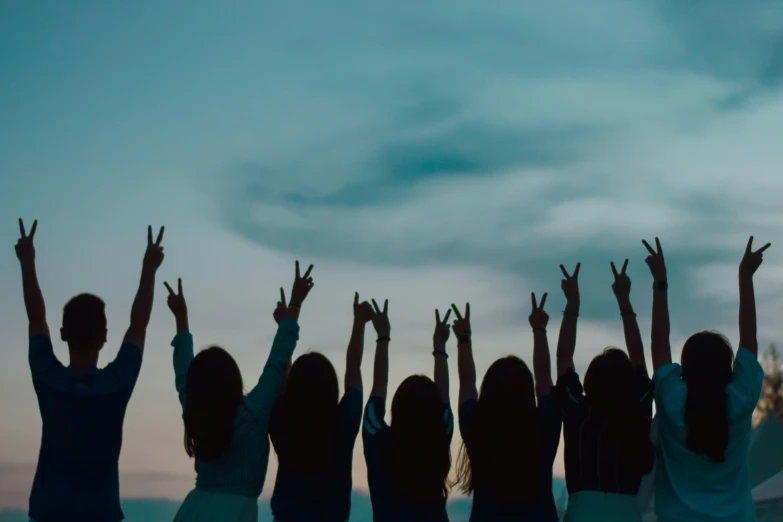 group of people reaching up in the air