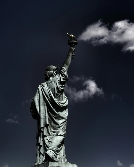 a very big pretty statue with some clouds