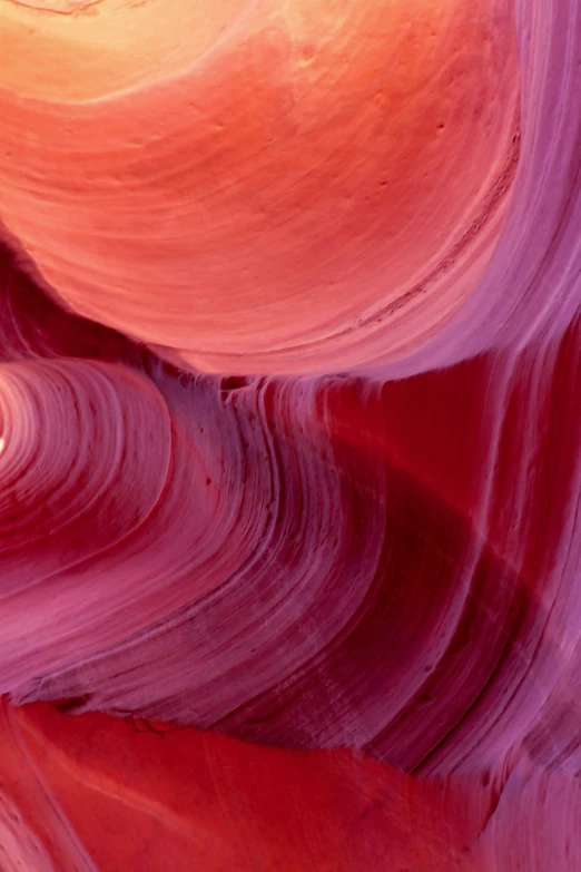 a rock formation that is red, pink and purple with other colors on it