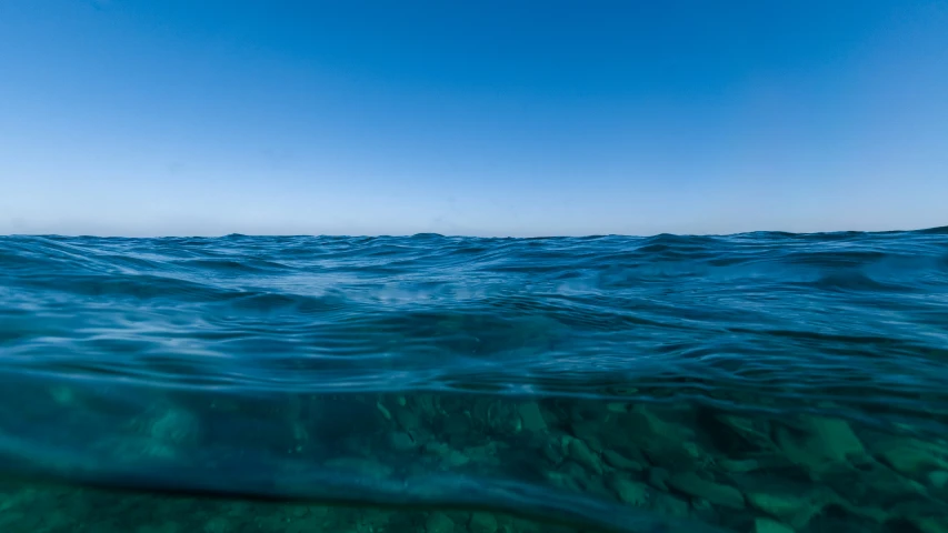 view of water surface from an ocean moving through frame