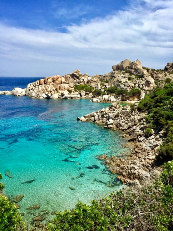 blue water and rocky shore with clear sky