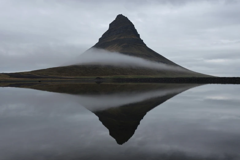 clouds moving over the mountains and surrounding water