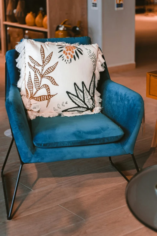 a blue chair with a large cushion in it