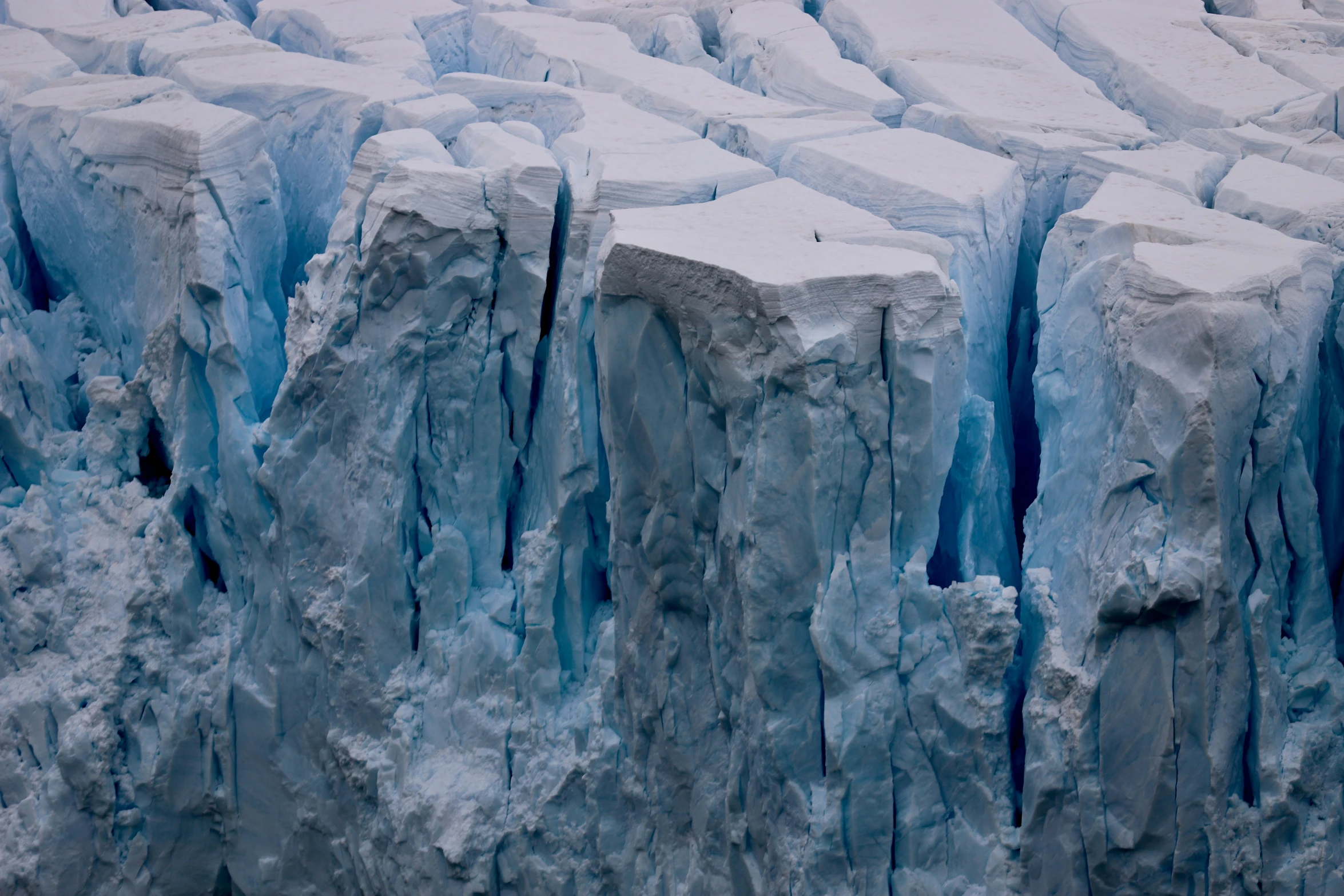 large ice blocks that have melting and are forming a wave