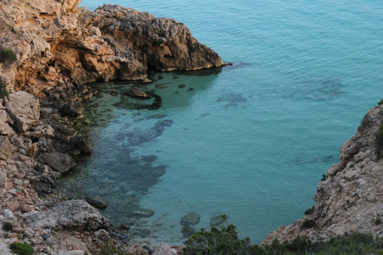 a very large rock outcropping over water