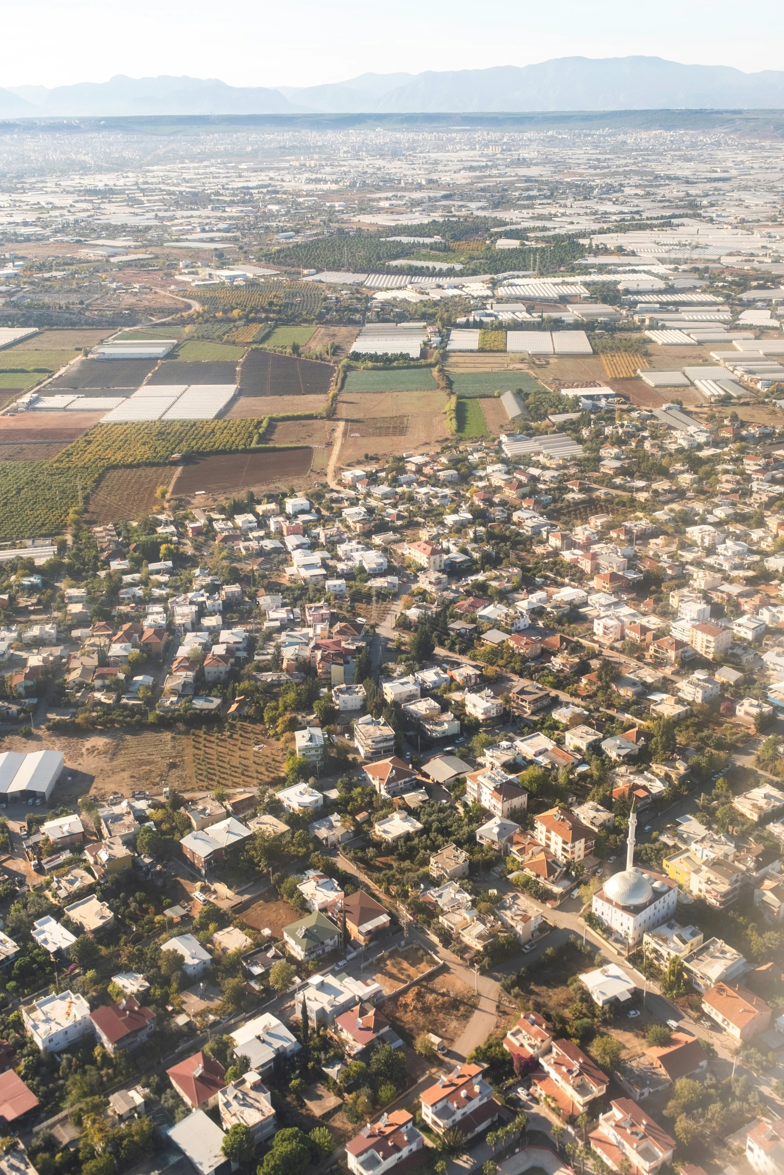 the view from an airplane shows small town with lots of houses