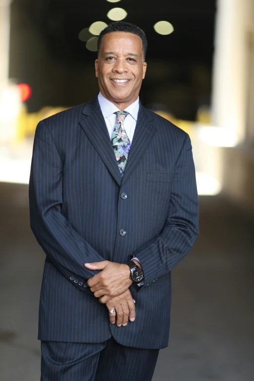 a man with his hands together in a business suit