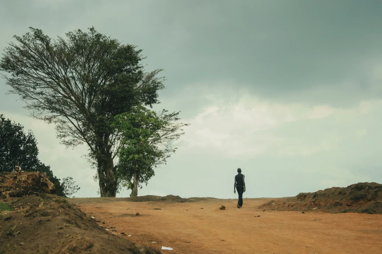 a man stands in the middle of an empty road