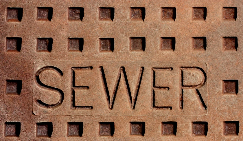 the word sever in rough cutouts on an old brown brickstone