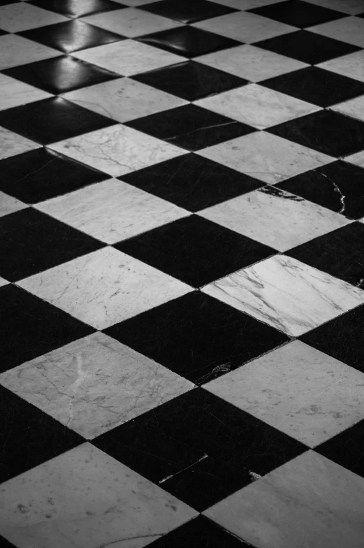 a checkered floor with a umbrella in the back