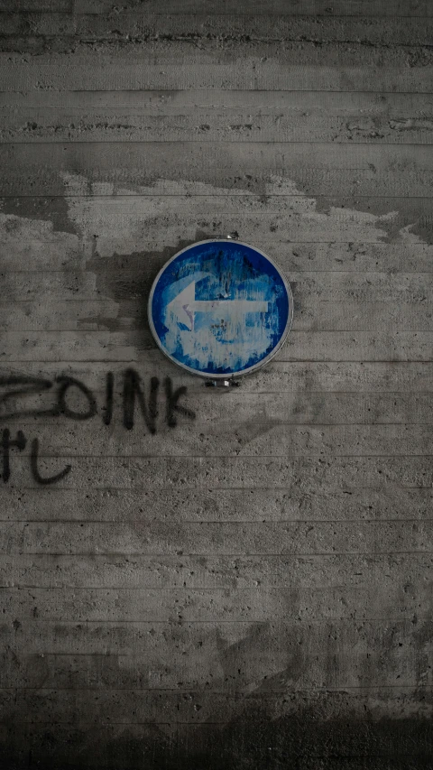 a blue plate on top of an asphalt road