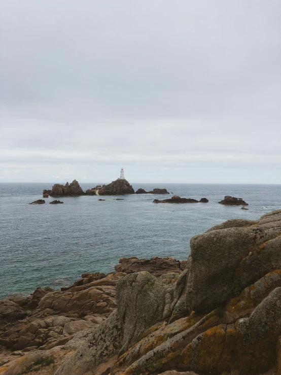 the ocean with the rocks on it and some seaweed