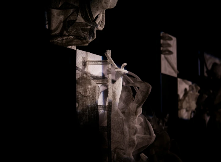 a black background shows the top of a sculpture and several images