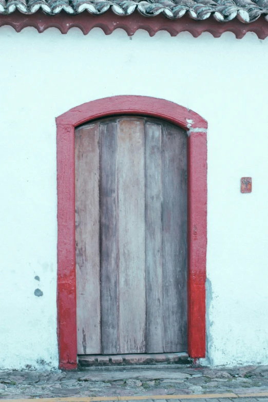 a door and entrance of an old brick and stucco building