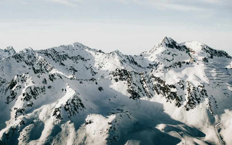 view from a snowy mountain with a few white clouds