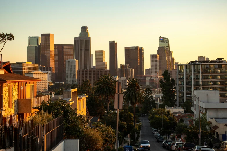 a view of the sun setting over city skyline