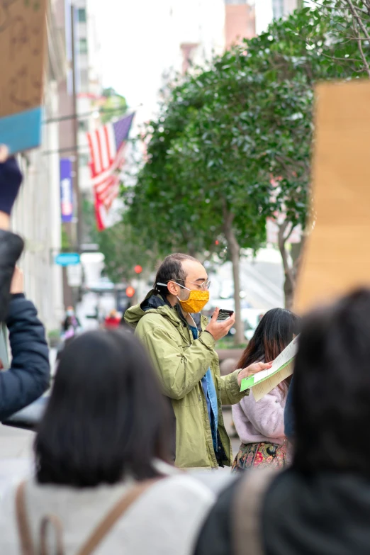 a man that is standing in the street with a mask