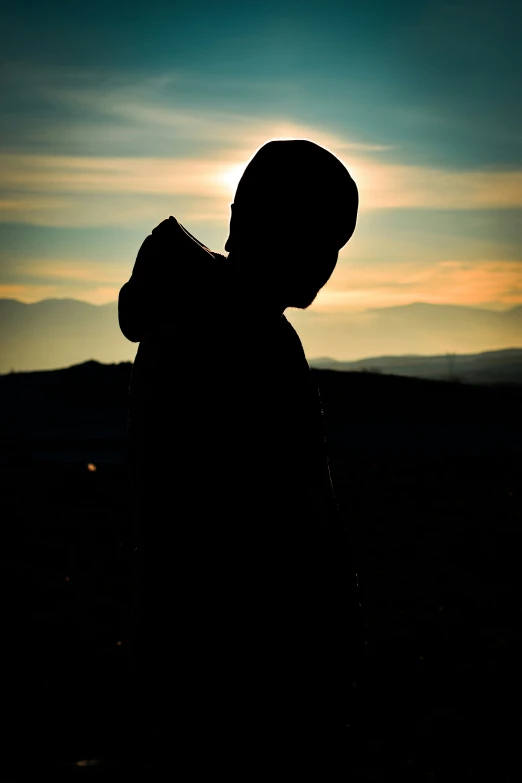 silhouetted person in evening, with one shadow visible on the left