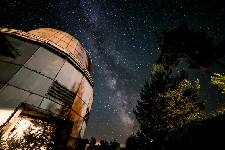 a satellite telescope with a night sky full of stars