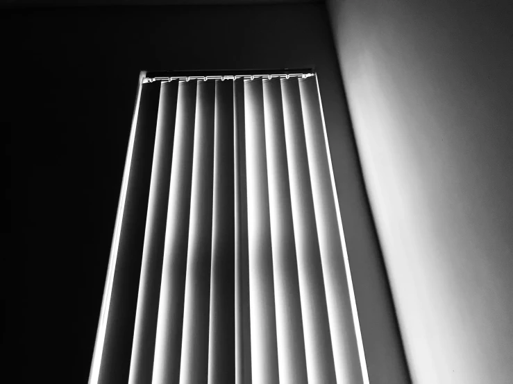 a long thin white window with the blind closed