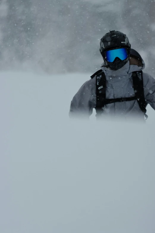 a person skiing in the snow and wearing a snowboard