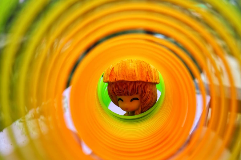 a toy head sitting inside of a large yellow object