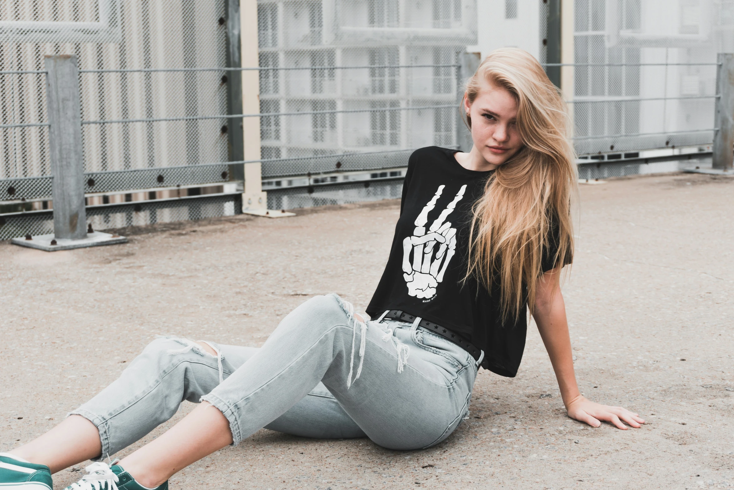 a girl laying down outside on the ground