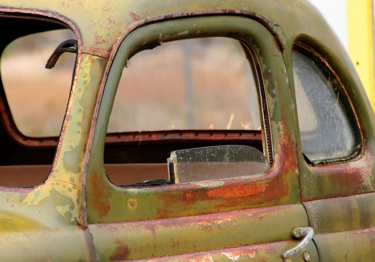 the paint peeling off the side of a old car