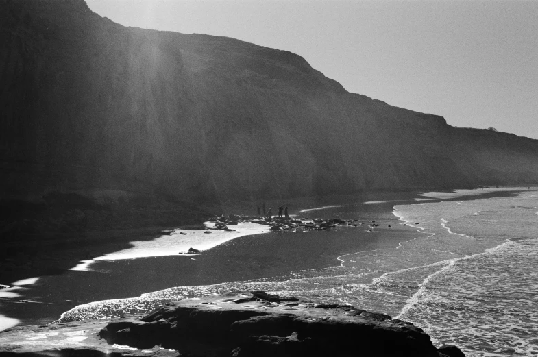 black and white po of coastline with boat in the water