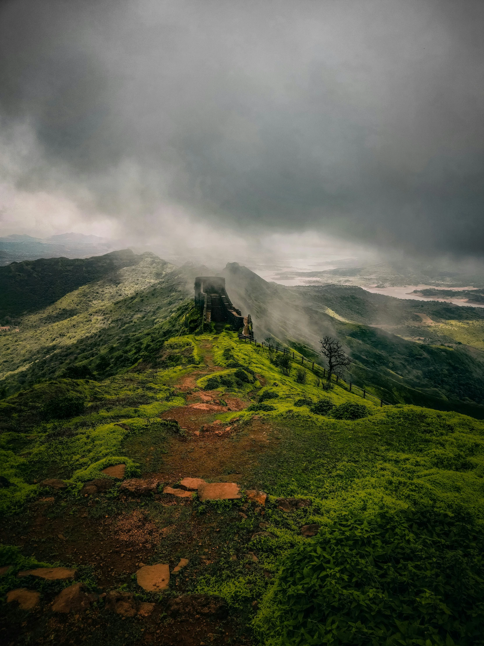 some very tall mountains with grass on the ground