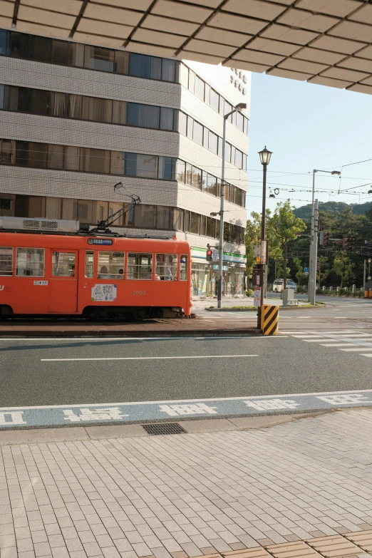 an orange train on tracks in the city