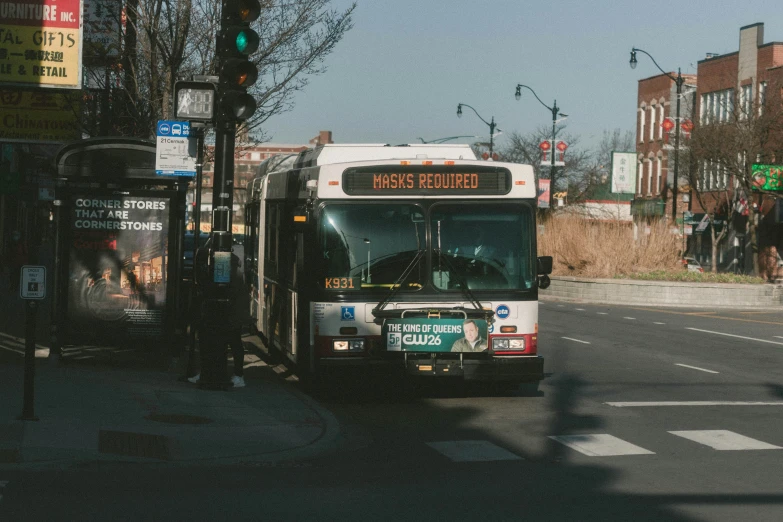 a bus is at a cross walk near an intersection