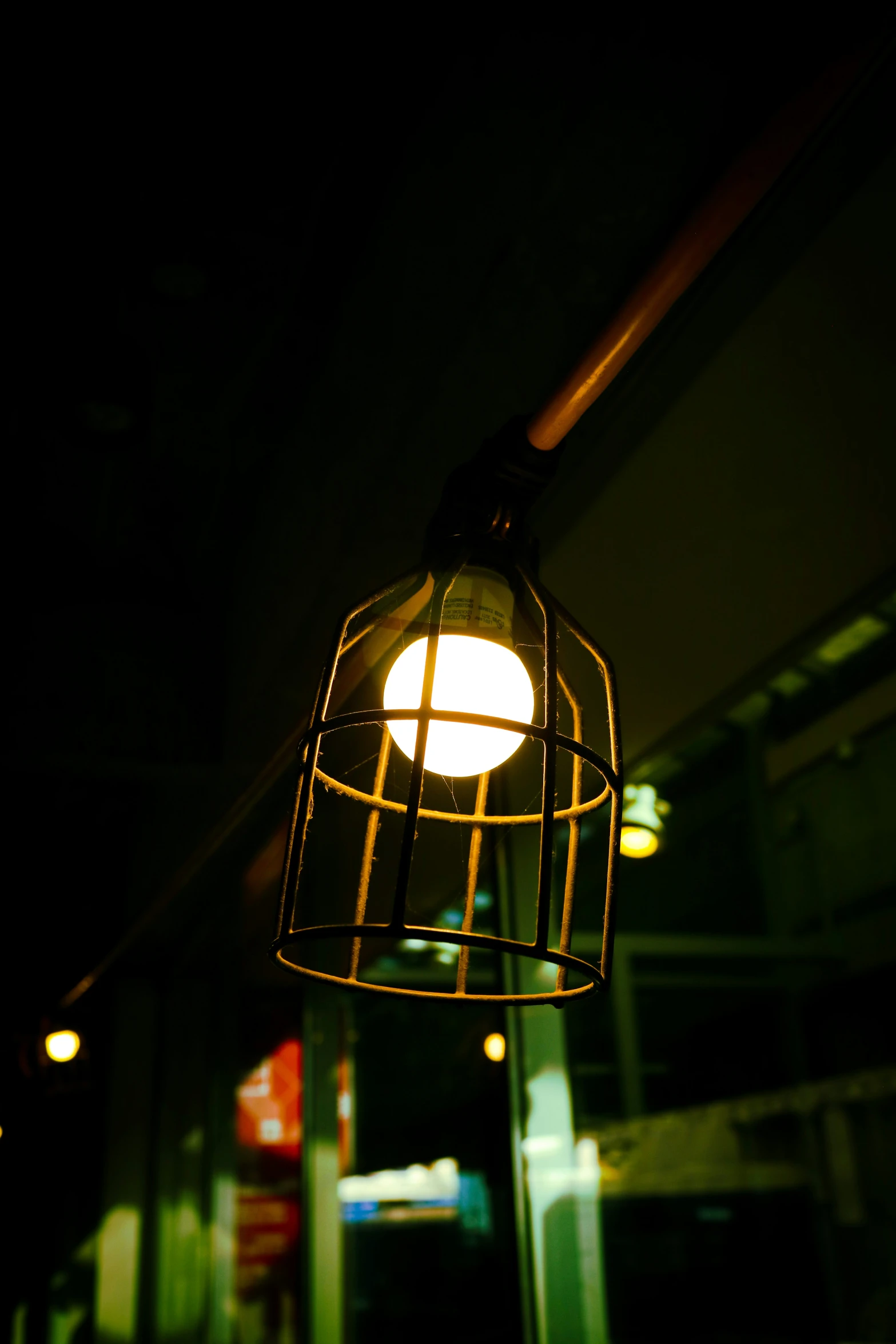 a dark alley with lights hanging from it