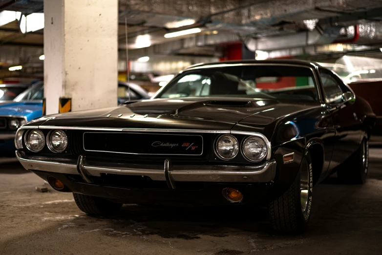 a black car is parked inside a car garage