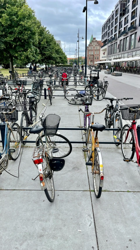 bicycles are lined up in the street near a road light