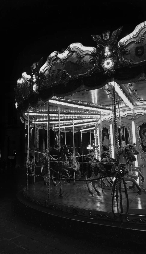 a black and white po of people on a merry go round