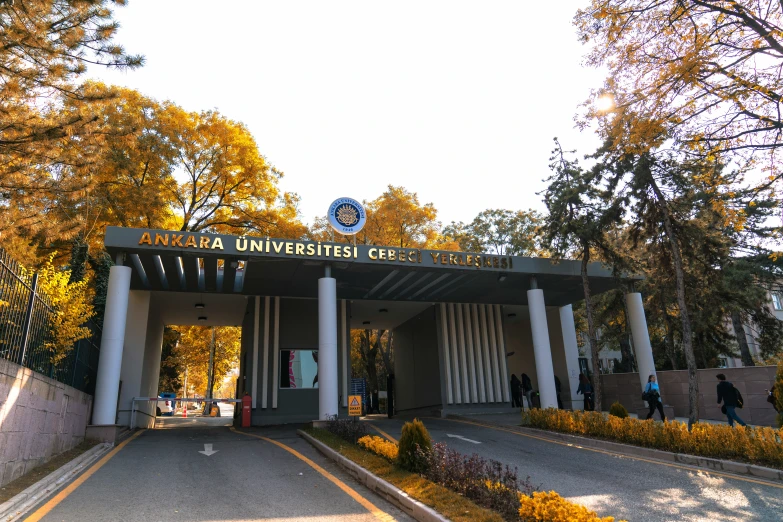 the entrance to the university center is surrounded by greenery