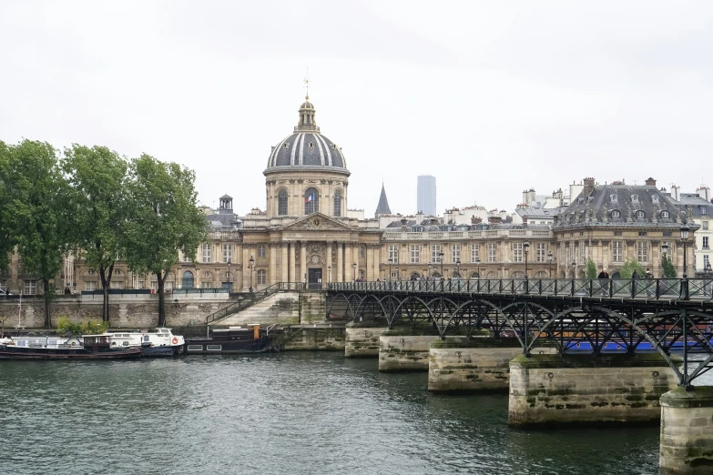 a large building with many windows near a river